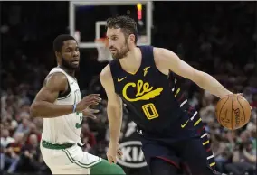  ?? TONY DEJAK — THE ASSOCIATED PRESS ?? Kevin Love drives against the Celtics on March 4at Rocket Mortgage FieldHouse.