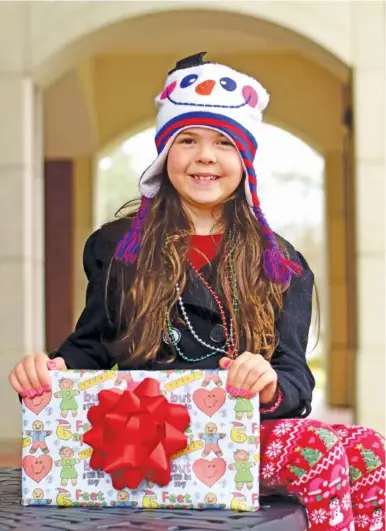  ?? STAFF PHOTO BY ROBIN RUDD ?? Seven-year old Kariyana Donev is the 2020 winner in the Chattanoog­a Times Free Press’ Lin C. Parker Wrapping Paper Design Contest.