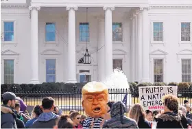  ?? CAROLYN KASTER/ ASSOCIATED PRESS ?? A person dressed to look like President Donald Trump in a prison uniform was part of a crowd gathered Monday in front of the White House in Washington to protest Trump’s national emergency on the border.