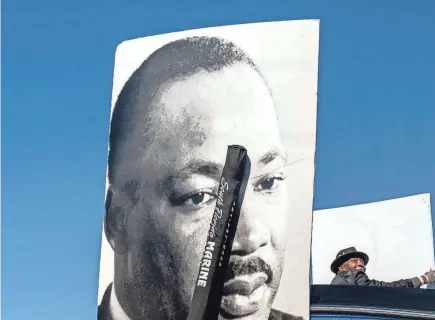  ?? GREG LOVETT/PALM BEACH POST ?? The Lindsey Davis senior program is represente­d with large photos during the Martin Luther King Jr. Day Parade along Blue Heron Boulevard in Riviera Beach on Jan. 14, 2023.