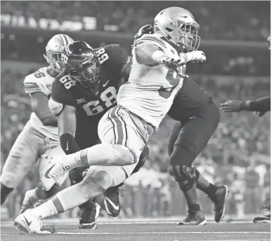  ??  ?? Ohio State defensive end Nick Bosa goes up against Texas Christian tackle Anthony McKinney in the first quarter at AT&T Stadium on Sept. 15.