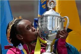  ?? AP ?? Rita Jeptoo of Kenya kisses the trophy after winning the women’s division of the 118th Boston Marathon. —