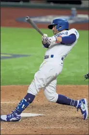  ?? RONALD MARTINEZ / Getty Images ?? The Dodgers’ Mookie Betts hits a solo home run against the Rays during Game 6 of the World Series on Tuesday at Globe Life Field in Arlington, Texas.