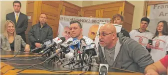  ?? ANDYGRIMM/ SUN- TIMES ?? Jose Juan Maysonet Jr. ( right) speaks at a Loop news conference Monday. To his right is Roberto Almodovar Jr., another former inmate who was exonerated and freed.