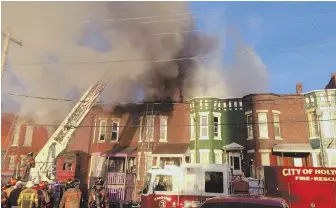  ?? Photo courtesy of holyoke fire department ?? SMOKY SCENE: Holyoke firefighte­rs respond to a three-alarm blaze on Saturday. Fire Capt. Kevin Cavagnac says the victim in the fatal inferno ‘possibly’ alerted residents.