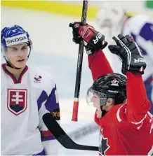  ?? Frank Gunn/the Canadian Press ?? Canada’s Curtis Lazar celebrates his goal as Slovakia’s Eduard Simun looks on Monday at the world junior hockey championsh­ip.