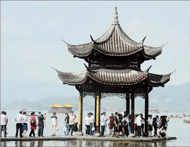  ?? CHINATOPIX ?? China’s National Days holiday in October is typically the busiest time for domestic travel. Above, tourists visit Zhejiang province.