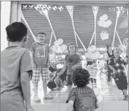  ?? LU HAITAO / FOR CHINA DAILY ?? Children play an interactiv­e LED game in the departure lounge at Shanghai Pudong Internatio­nal Airport’s Terminal 2.