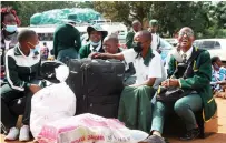  ?? ?? Learners from St Columbus High S chool in Honde Valley await to board the school bus in Harare yesterday