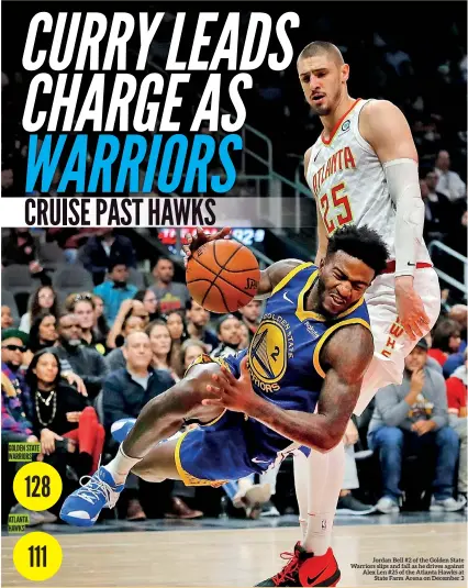  ??  ?? Jordan Bell #2 of the Golden State Warriors slips and fall as he drives against Alex Len #25 of the Atlanta Hawks at State Farm Arena on December 3