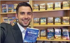  ?? ANDY STEVES VIA AP ?? This undated photo shows travel guidebook writer Andy Steves holding a copy of his book “Andy Steves’ Europe: City-Hopping on a Budget” at the Berkeley offices of his publisher Avalon Travel. Steves is the son of Rick Steves, the well-known travel...