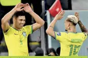  ?? ?? Brazil's midfielder #05 Casemiro (L) celebrates with Brazil's midfielder #19 Antony after he scored his team's first goal during the Qatar 2022 World Cup Group G football match between Brazil and Switzerlan­d