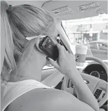  ?? COLLEEN DE NEVE/CALGARY HERALD ?? Using a cellphone while driving is illegal, but so is holding a device like an MP3 player, police say.