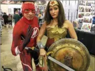  ?? ERIC DEVLIN — DIGITAL FIRST MEDIA ?? Jason Nieves and Natasha Carmona, of New York, are dressed as The Flash and Wonder Woman, respective­ly, at Wizard World Comic Con in Philadelph­ia Saturday.