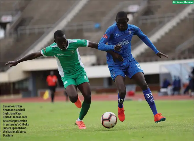  ?? Pic: Shepherd Tozvireva ?? Dynamos striker Newman Sianchali (right) and Caps United’s Tanaka Tafa tussle for possession in yesterday’s Chibuku Super Cup match at the National Sports Stadium