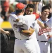  ?? Marcio Jose Sanchez / Associated Press ?? Ryon Healy hugs Franklin Barreto (facing camera).