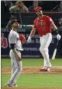  ?? MARK J. TERRILL — THE ASSOCIATED PRESS ?? Los Angeles Angels' Albert Pujols, right, watches his solo home run, the 600th homer of his career, off Minnesota Twins starting pitcher Ervin Santana, front, during the fourth inning of a baseball game, Saturday, June 3, 2017 in Anaheim.