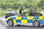  ?? Pictures: Steven Brown/Perthshire Picture Agency. ?? A police car at Gleneagles Hotel soon after the raid; DCI Andy Patrick speaks to the media, top right; armed police hunt for the raiders, above centre; and police beside the abandoned Audi, close to the hotel.