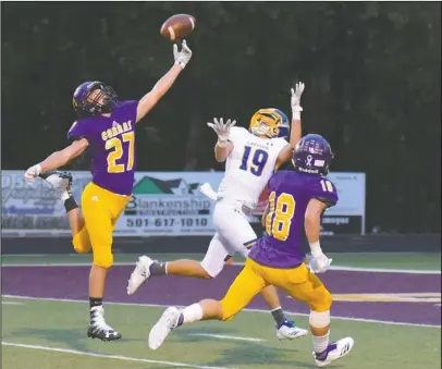  ?? The Sentinel-Record/Jami Smith ?? CATCH DENIED: Fountain Lake sophomore Asa Westerman (27) tips the ball away from Lakeside sophomore Ty Davis (19) as senior Kyle Fortner (18) defends last Friday night at Allen Tillery Field. The Cobras defeated the Rams, 40-27.