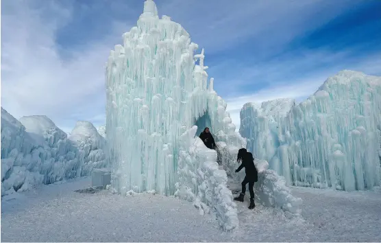  ?? ED KAISER ?? A crew of around 20 people has worked since October to create this year’s Edmonton ice castle in Hawrelak Park, first laying a series of pipes, sprinklers and ice before creating columns of ice that are connected together to create the structure’s...