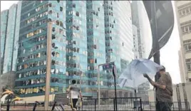  ?? REUTERS ?? ■ Windows of the One Harbourfro­nt office tower in Hong Kong are damaged by the typhoon.