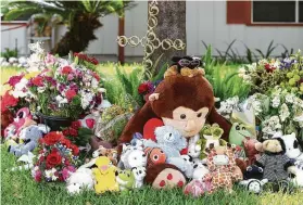  ?? Godofredo A. Vasquez / Houston Chronicle ?? A memorial of flowers and gifts sits in front of the home of Pam Johnson on Tuesday. The 62-year-old was remembered by her sister as “a kid at heart.”