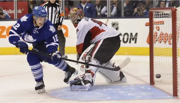 ?? RICHARD LAUTENS/TORONTO STAR ?? Winger Mason Raymond, left, beats Ottawa goalie Craig Anderson in the shootout as the Leafs took the first skirmish in this year’s Battle of Ontario on Saturday night. More on Raymond, S2.