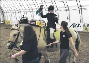  ??  ?? Relying primarily on donations and fundraisin­g, Rainbow Riders operates from a facility that currently houses 14 horses and provides an indoor riding arena to support year-round operation. This work is only possible with the assistance of generous...