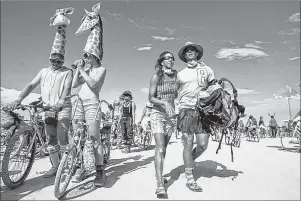  ?? AP PHOTO ?? In this 2007 file photo, Burning Man festival participan­ts walk in Center Camp in Gerlach, Nev. The #MeToo movement is making its way to Burning Man that began Sunday.