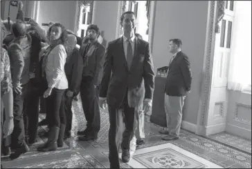  ?? The Associated Press ?? CLOSED-DOOR MEETING: Sen. Tom Cotton, R-Ark., walks towards the Senate floor Friday after a closed-door meeting with Republican lawmakers to advance the GOP overhaul of the tax code on Capitol Hill in Washington.