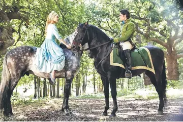  ??  ?? Lily James as Cinderella, left, and Richard Madden as the Prince in Disney's live-action feature inspired by the classic fairy tale, 'Cinderella'. — Courtesy of Disney