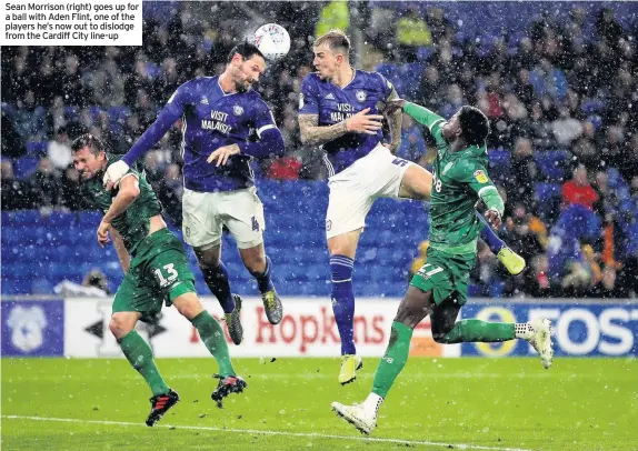  ??  ?? Sean Morrison (right) goes up for a ball with Aden Flint, one of the players he’s now out to dislodge from the Cardiff City line-up