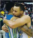  ?? DAVID GOLDMAN — THE ASSOCIATED PRESS ?? The Warriors’ Stephen Curry, right, embraces Kent Bazemore, then of the Atlanta Hawks, after a game in 2017.