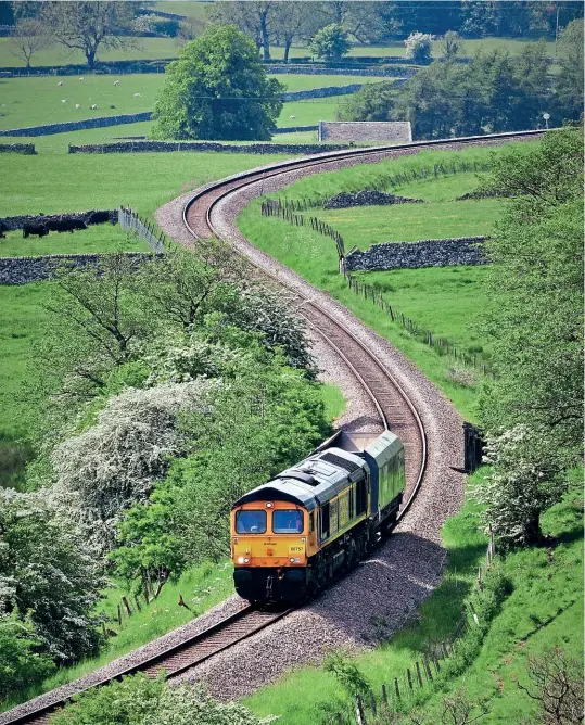  ?? Brian Newton ?? It's always unusual to see a 3200hp ‘Type 5' locomotive hauling a single wagon, but one such working occurred on June 5, when GBRf Class 66 No. 66757 West Somerset Railway worked the 4D75 17.07 Rylstone-Doncaster Down Decoy Yard. The loco and its ‘train' are seen negotiatin­g the impressive ‘S' curve near Rylstone, on the freight only branch from Skipton, running 58 minutes early from Swinden Quarry.