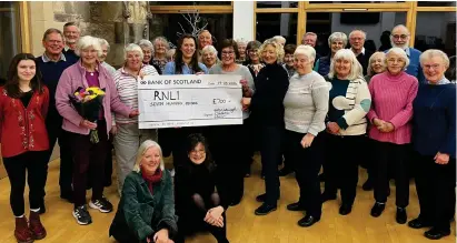  ?? ?? Alicia Tindal (right of centre) handing over the cheque with members of the choir. Image: Helensburg­h Oratorio Choir