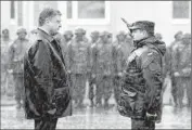  ??  ?? UKRAINIAN PRESIDENT Petro Poroshenko is greeted by a soldier at the Yavoriv training center.