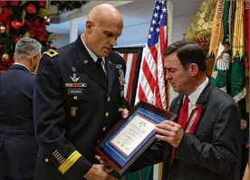  ?? U.S. ARMY PHOTO BY SGT. STEVEN LEWIS ?? Staff Sgt. Dustin M. Wright’s father, Arnold Wright, receives the Silver Star medal citation from Maj. Gen. E. John Deedrick Jr., Commanding General of 1st Special Forces Command (Airborne), during a posthumous award ceremony Wednesday.