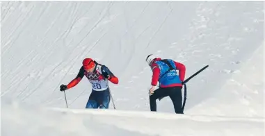  ?? KIRILL KUDRYAVTSE­V/ AFP/ GETTY ?? Canadian coach Justin Wadsworth helps Russian skier Anton Gafarov after Gafarov crashed in the men’s cross- country skiing individual sprint free semifi nals earlier this week at the Sochi Winter Olympics . Wadsworth was applauded for showing the true spirit of the Olympics by Gafarov, who had a broken ski, fi nish the race . Wadsworth is an American who married 2002 cross- country gold medallist Beckie Scott of Vermilion, Alta.