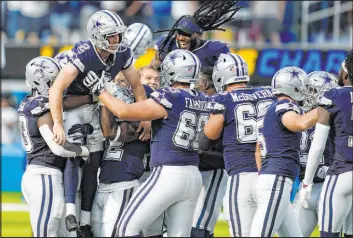  ?? The Associated Press ?? Gregory Bull
Dallas Cowboys kicker Greg Zuerlein (2) is lifted by teammates after making the game-winning field goal from 56 yards to beat the L.A. Chargers in Inglewood, Calif.