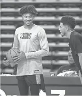  ??  ?? Forward Kelly Oubre laughs with guard Devin Booker during Suns practice at the Rolle Activity Center at Northern Arizona University in Flagstaff on Oct. 2, 2019.
