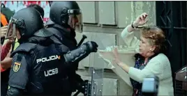  ??  ?? ‘SAVAGE’: Riot police confront a woman near a polling station last week