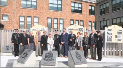  ?? GLEN WHIFFEN/THE TELEGRAM ?? Officials and members of the Memorial on Parade Commemorat­ive Parkette Committee pose on the Memorial on Parade Parkette that was dedicated during a ceremony Wednesday at Fort Townshend in St. John’s.