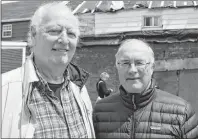  ??  ?? Cape Breton University professor emeritius Harvey Johnstone and Ken Donovan, vice-chair of the Sydney Architectu­ral Conservati­on Society, were on site Tuesday examining the back of the Red Brick Row building in Sydney Mines.