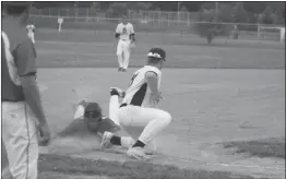  ?? STAFF PHOTO BY MICHAEL REID ?? Western Charles’ Tyler Summers slides in safely ahead of the tag of Junkyard Dogs infielder Hunter Rooney to steal third base in the second inning of Tuesday’s 19-4 win at Chancellor’s Run Regional Park in Great Mills.