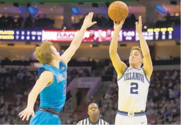  ?? MITCHELL LEFF/GETTY IMAGES ?? Villanova’s Collin Gillespie shoots the ball over Georgetown’s Mac McClung Sunday at Wells Fargo Center in Philadelph­ia. Villanova defeated Georgetown 77-65.