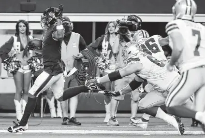  ?? Brett Coomer / Staff photograph­er ?? Lonnie Johnson Jr. races down the sideline as he returns an intercepti­on for a touchdown against the Cowboys. Johnson is in a battle with Eric Murray to start at safety for the Texans opposite Justin Reid.