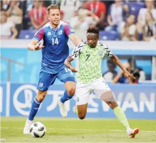  ??  ?? Iceland's Kari Arnason (L) and Nigeria's Ahmed Musa fight for the ball in their 2018 FIFA World Cup Group D match at Volgograd Arena Stadium on June 22, 2018 Photo: Getty Images