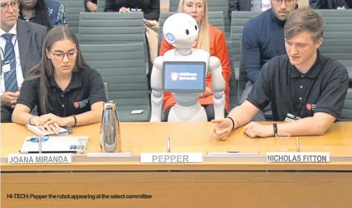  ??  ?? HI-TECH: Pepper the robot appearing at the select committee