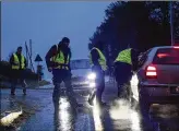  ?? ASSOCIATED PRESS ?? Police check documents near the scene of a blast in Poland on Wednesday. A Russianmad­e missile fell in the country’s east, killing two.