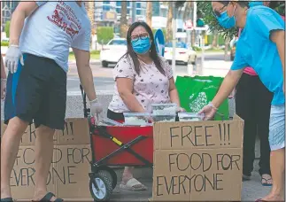  ??  ?? Feby Dela Pena hands out free food.